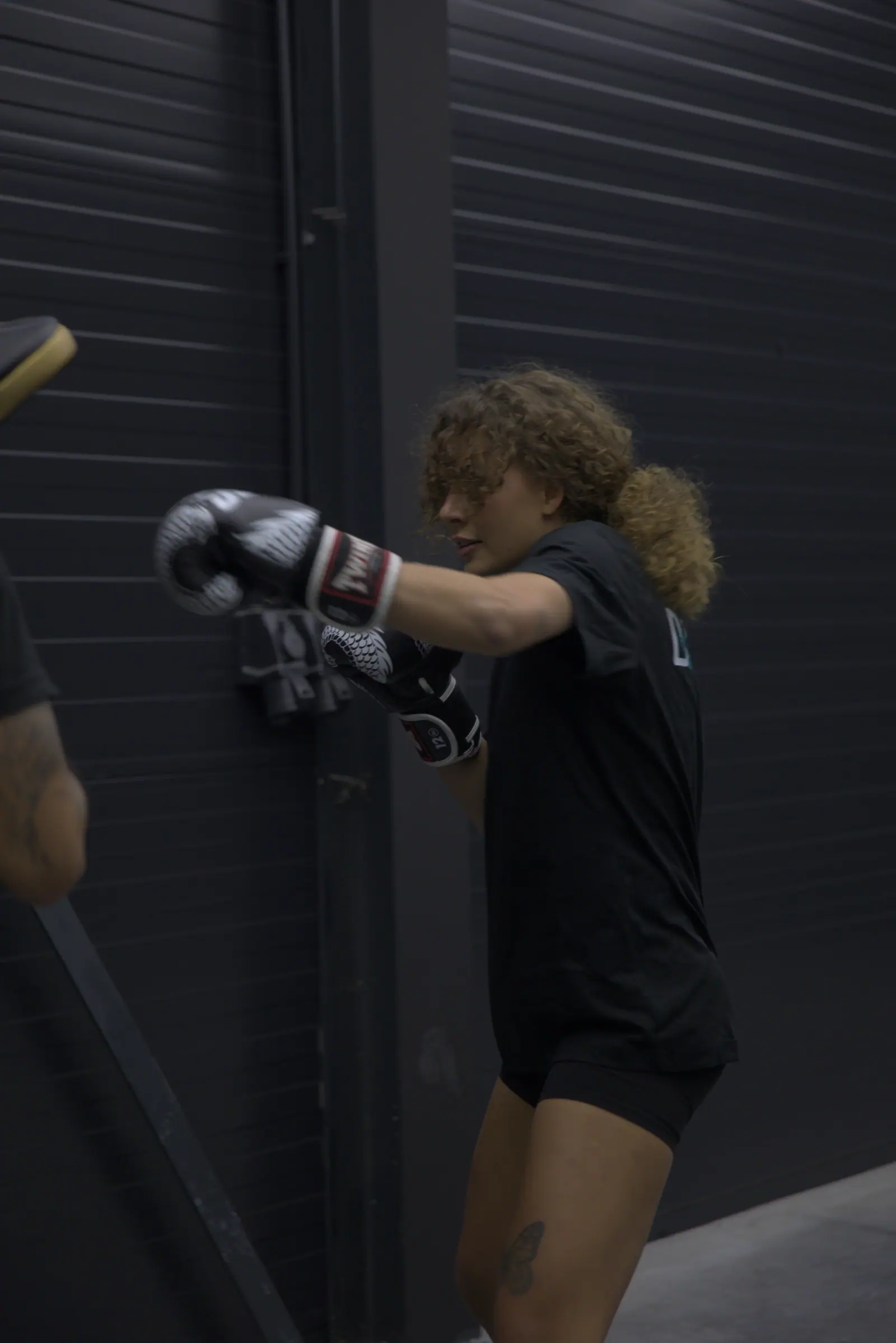 Boksster traint aan de bokszak in de zaal van Dozmic Boxing
